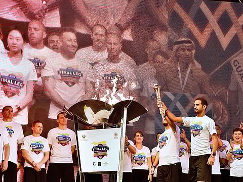 Torch-bearers Daniel Fundora and Yasser Al Zaabi at the closing ceremony of the Host Town Programme at Global Village on Sunday before the Special Olympics World Games Abu Dhabi.