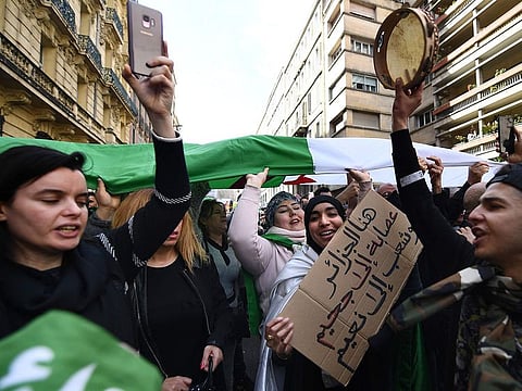 Demonstrators shout slogans and wave placards during a rally in Marseille, southern France on March 10, 2019, in support of the ongoing protests in Algeria against the president's bid for a fifth term in power