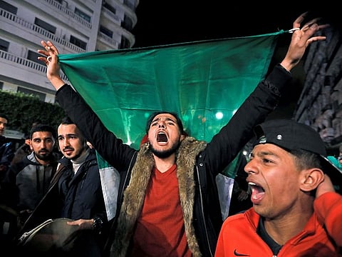 People celebrate on the streets after President Abdul Aziz Bouteflika announced he will not run for a fifth term, in Algiers, Algeria March 11, 2019.