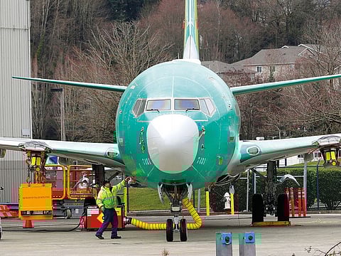 A worker stands near a Boeing 737 MAX 8 at Boeing Co.’s Renton Assembly Plant in Renton, Washington.