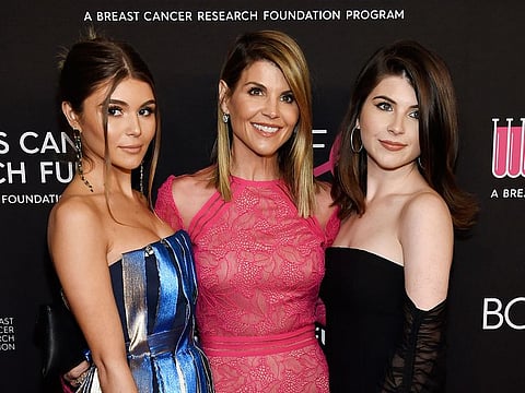 Actress Lori Loughlin, center, poses with daughters Olivia Jade Giannulli, left, and Isabella Rose Giannulli at the 2019 "An Unforgettable Evening" in Beverly Hills, California.