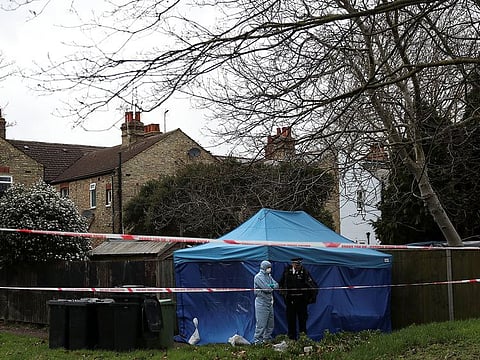 A forensic officer talks to a policeman outside a forensics tent at a property where the body of Laureline Garcia-Bertaux was found in Kew, London, Britain March 7, 2019.
