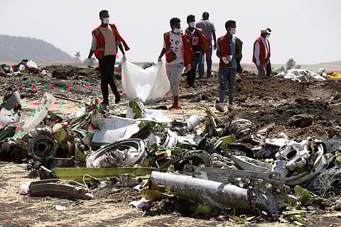 Ethiopian Red Cross workers carry a body bag with the remains of Ethiopian Airlines Flight ET 302 plane crash victims at the scene of a plane crash, near the town of Bishoftu, southeast of Addis Ababa, Ethiopia March 12, 2019. REUTERS/Baz Ratner