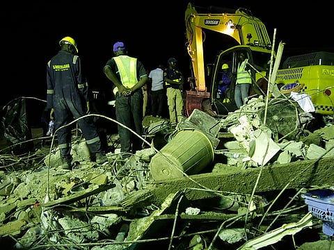 Emergency workers attend the scene after a building collapsed in Lagos, Nigeria, Wednesday March 13, 2019.