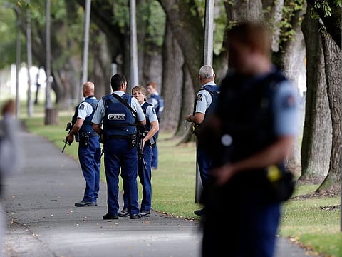Police keep watch at a park across the road from a a mosque in central Christchurch, New Zealand.