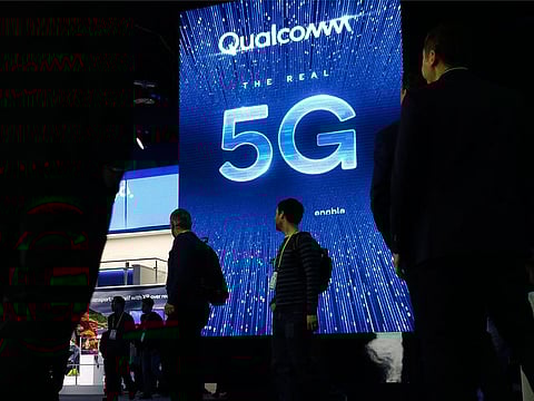 File photo a sign advertises 5G at the Qualcomm booth at CES International in Las Vegas. A jury announced the verdict that Apple should pay $31 million in damages for infringing on patents for technology owned by mobile chip maker Qualcomm that helps iPhones quickly connect to the internet and extend their battery life.