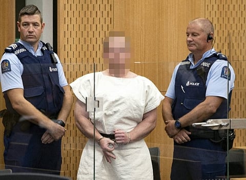 Brenton Tarrant, the accused Christchurch shooter, makes a white power sign during his court appearance