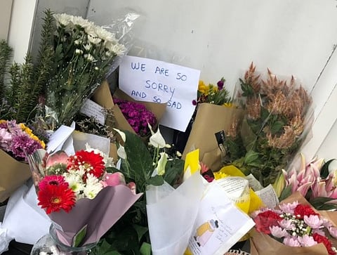 People leave flowers and messages of encouragement outside mosques around the world