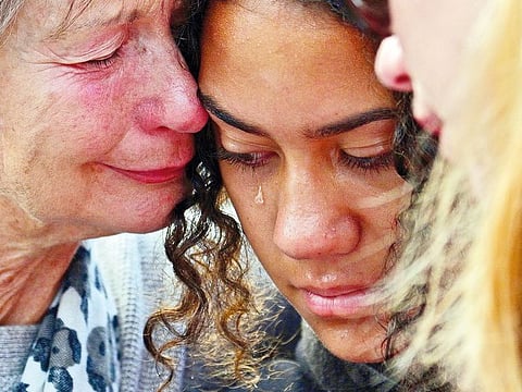 Residents cry after leaving flowers in tribute to victims in Christchurch after a shooting incident at two mosques in the city