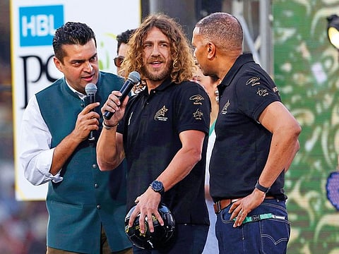 Retired Barcelona soccer player Carles Puyol, center, attends the closing ceremony of the Pakistan Super League, prior to the final cricket match at National stadium in Karachi, Pakistan