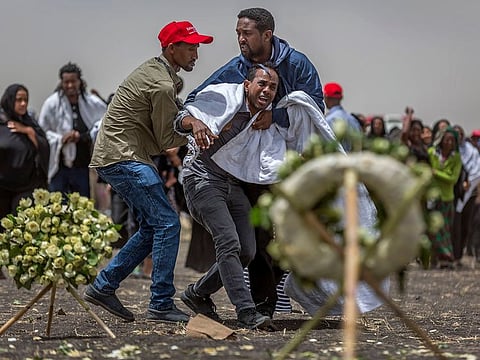 Ethiopian relatives of crash victims mourn and grieve at the scene where the Ethiopian Airlines Boeing 737 Max 8 crashed shortly after takeoff on Sunday killing all 157 on board