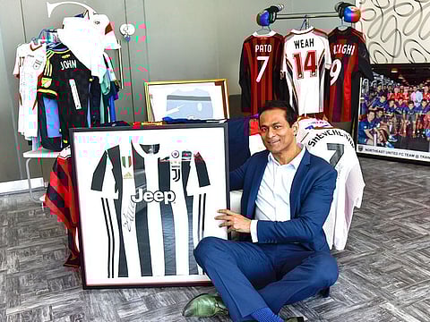 Dr. George John poses with Cristiano Ronaldo-signed Juventus jersey.