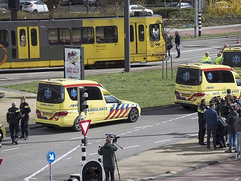 Ambulances are seen next to a tram after a shooting in Utrecht, Netherlands, Monday, March 18, 2019. Police in the central Dutch city of Utrecht say on Twitter that "multiple" people have been injured as a result of a shooting in a tram in a residential neighborhood.