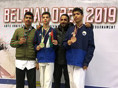 Sinan Ashfaq, Omar Yaser, Coach Abdullah Hatim and Abdullah Al Faheem celebrate after winning medals at the Belgium Open Taekwondo Championship G2