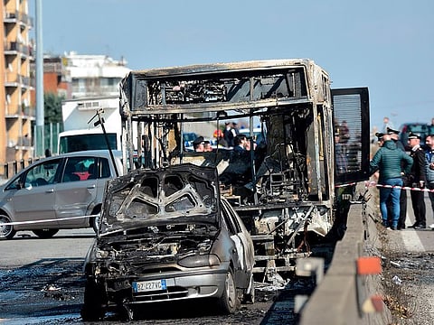 The wreckage of a school bus that was transporting some 50 children is pictured on March 20, 2019 after it was torched by the bus' driver, in San Donato Milanese, southeast of Milan.