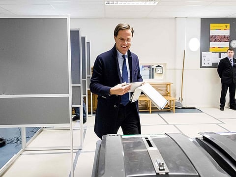 Dutch Prime Minister Mark Rutte exits a polling booth to cast his ballot.