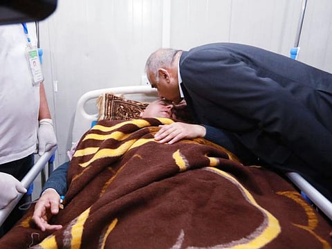 Iraqi Prime Minister Adel Abdul Mahdi on it's Facebook page shows him (R) kissing the head of a man, who survived the Tigris ferry sinking, in a hospital in Mosul on March 21.