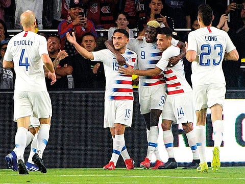 US forward Gyasi Zardes (9) is congratulated by teammates after scoring a goal during a friendly against Ecuador.