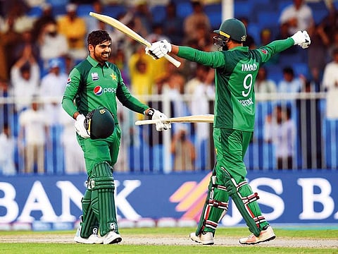 Haris Sohail of Pakistan celebrates his century with Imad Wasim during the first One-dayer against Australia at the Sharjah Cricket Stadium