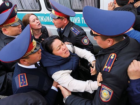 Police officers detain anti-government protesters during a rally in Almaty, Kazakhstan.