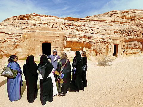 Visitors tour the rock-hewn tombs of Madain Saleh near the city of Al Ula.