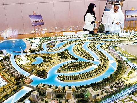 Visitors looking at the model of Ajmal Makan Sharjah Waterfront City project at Acres Middle East Investment Real Estate Exhibition at the Expo Centre Sharjah.