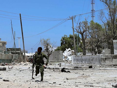 A Somali soldier runs to hold position as Al Shabaab militia storms a government building in Mogadishu, Somalia March 23, 2019.