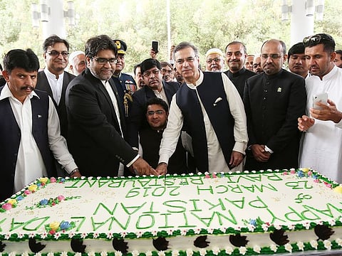 Pakistan's Ambassador to UAE Moazzam Ahmad Khan cuts the cake to celebrtae Pakistan national day celebration at the embassy premises in Abu Dhabi.