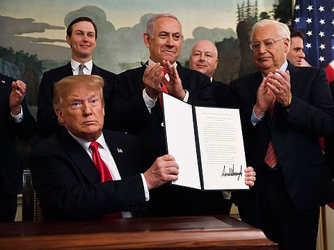 President Donald Trump holds up a signed proclamation recognizing Israel's sovereignty over the Golan Heights, as Israeli Prime Minister Benjamin Netanyahu looks on in the Diplomatic Reception Room of the White House in Washington, Monday, March 25, 2019.