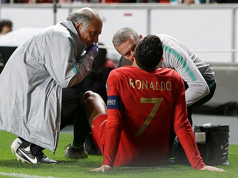 Portugal's Cristiano Ronaldo receives treatment from medical staff.
