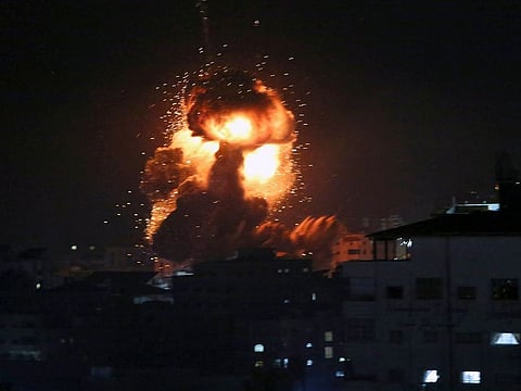 An explosion caused by Israeli airstrikes is seen from the offices of Hamas leader Ismail Haniyeh, in Gaza City, Monday, March 25, 2019.