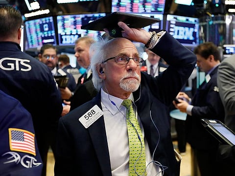 A trader works on the floor of the New York Stock Exchange.