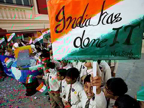 Students cheer as they raise flags to celebrate after India shot down one of its satellites in space with an anti-satellite missile in a test, inside their school premises in Ahmedabad.