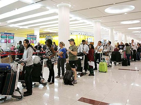 Passengers wait in line at the Dubai International Terminal 3.