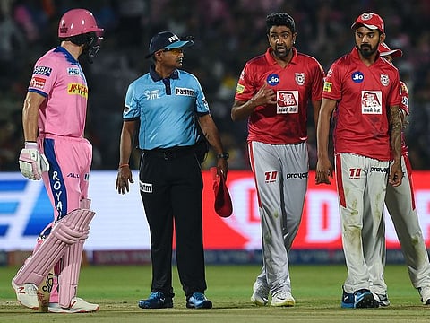 Rajasthan Royals' Jos Buttler (L) exchanges words with Kings XI Punjab's Ravichandran Ashwin.