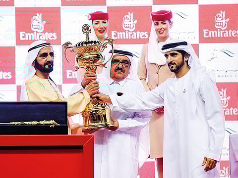 Shaikh Mohammad holds the Dubai World Cup with Shaikh Hamdan Bin Mohammad Bin Rashid Al Maktoum, Crown Prince of Dubai and Chairman of the Dubai Executive Council, and Shaikh Hamdan Bin Rashid Al Maktoum, Deputy Ruler of Dubai and Minister of Finance, after Thunder Snow made history by becoming the first dual winner