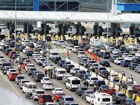 Cars queue up in multiple lines as they wait to be inspected by US border patrol officers to enter from Mexico in Tijuana on Friday.