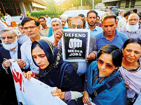 Journalists chant slogans during a march held to protest against layoffs and the non-payment of salaries, in Karachi, in February.