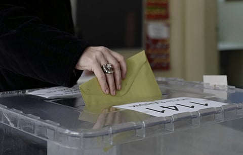 A woman casts her ballot at a polling station during the municipal elections, in Ankara, Turkey, Sunday, March 31, 2019.