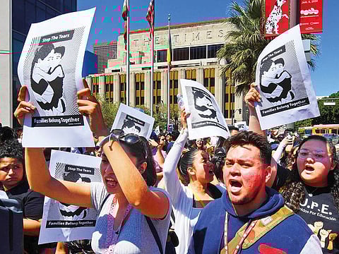 Migrant rights protesters demonstrate against forced family separations on the US Mexico border, outside police headquarters in Los Angeles on March 30, 2019.