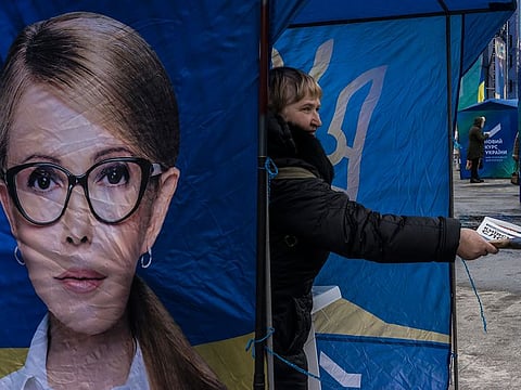 A volunteer for the presidential campaign of Yulia Tymoshenko, a former prime minister, hands out literature before a rally in Kiev, Ukraine, Feb. 9, 2019.
