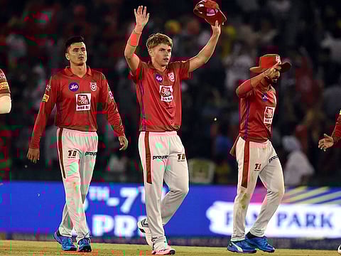 Kings XI Punjab (KXIP) player Sam Curran and team members celebrate after claiming the wicket of DC's Colin Ingram.