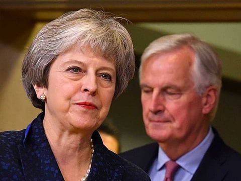 In this Nov. 24, 2018 file photo, British Prime Minister Theresa May, left, walks ahead of European Union chief Brexit negotiator Michel Barnier at EU headquarters in Brussels.