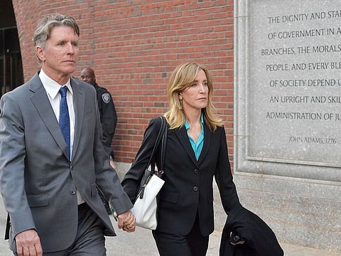Felicity Huffman exits the John Joseph Moakley U.S. Courthouse after appearing in Federal Court to answer charges stemming from college admissions scandal on April 3, 2019 in Boston, Massachusetts.