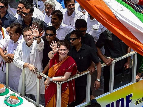 Congress President Rahul Gandhi with party General Secretary and Uttar Pradesh - East in charge Priyanka Gandhi Vadra and other leaders wave at party supporters during a roadshow after filing his nomination papers for Lok Sabha elections, in Wayanad, Thursday, April 4, 2019.