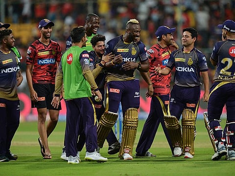 Kolkata Knight Riders teammates greet batsman Andre Russell (C) after he led the team's victory during the 2019 Indian Premier League (IPL) Twenty20 cricket match between Royal Challengers Bangalore and Kolkata Knight Riders at The M. Chinnaswamy Stadium in Bangalore on April 5, 2019.  Kolkata Knight Riders chased and won a target of 206 runs set by Royal Challengers with five wickets in hand.