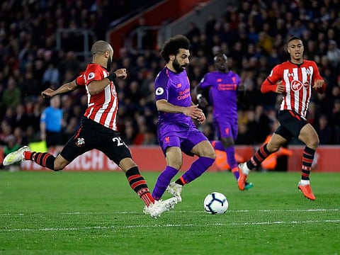 Liverpool's Mohammad Salah, center, scores his side's second goal during the English Premier League soccer match between Southampton and Liverpool at St Mary's stadium in Southampton, England Friday, April 5, 2019.