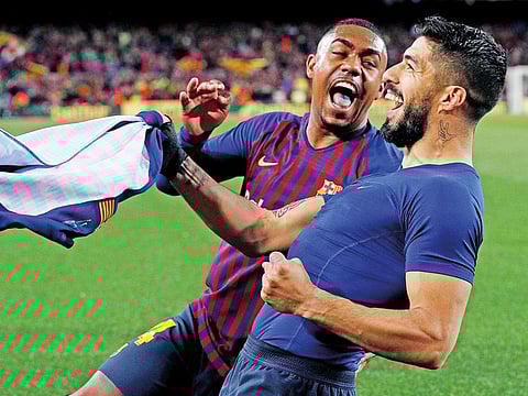 Barcelona's Luis Suarez celebrates scoring their first goal with Malcom during the La Liga Santander match against Atletico Madrid at Camp Nou, Barcelona, Spain, on April 6, 2019.