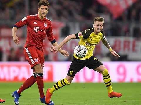 Dortmnund's midfielder Marco Reus (R) and Bayern Munich's midfielder Leon Goretzka (L) vie for the ball during the German first division Bundesliga football match FC Bayern Munich vs Borussia Dortmund in the stadium in Munich, southern Germany, on April 6, 2019.