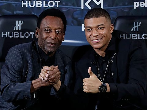 Brazilian soccer legend Pele, left, and French soccer player Kylian Mbappe pose during a photocall in Paris, Tuesday, April 2, 2019.